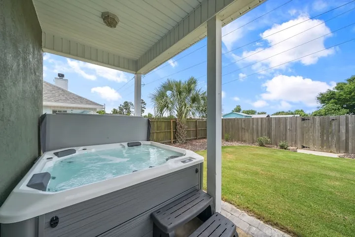 Private hot tub overlooking the fenced backyard